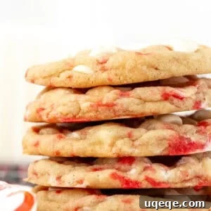 Peppermint Swirl White Chocolate Delights 7 Peppermint white chocolate chip cookies, stacked on top of another, emphasizing their tempting appeal.