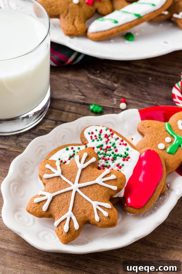 Melt-in-Your-Mouth Gingerbread Delights 3 A plate of soft gingerbread cookies decorated with royal icing - learn all the tricks for making the best gingerbread.