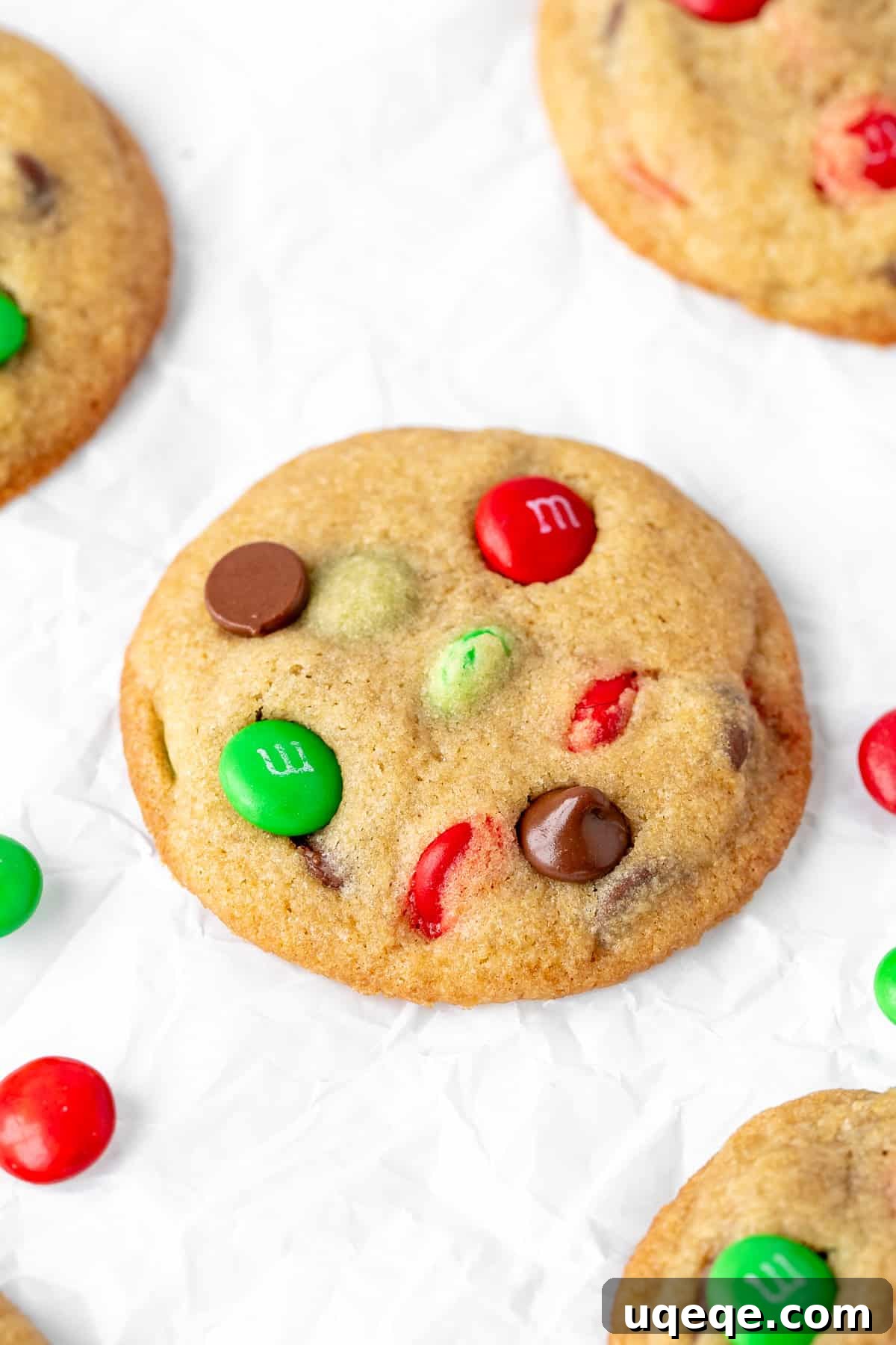 Festive M&M Delights 2 Christmas M&M cookies on baking paper, beautifully arranged and ready to be enjoyed.