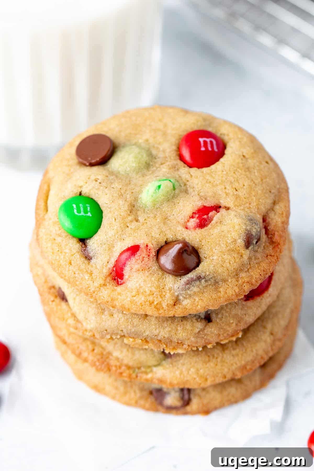 Festive M&M Delights 3 Stack of soft and chewy Christmas M&M cookies, filled with chocolate chips and festive M&Ms.