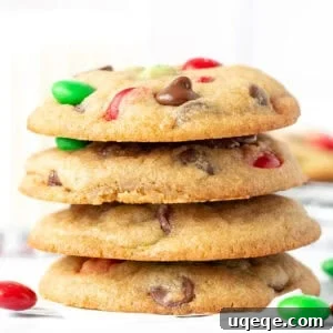 Stack of festive Christmas M&M cookies, showcasing their colorful candies and chocolate.