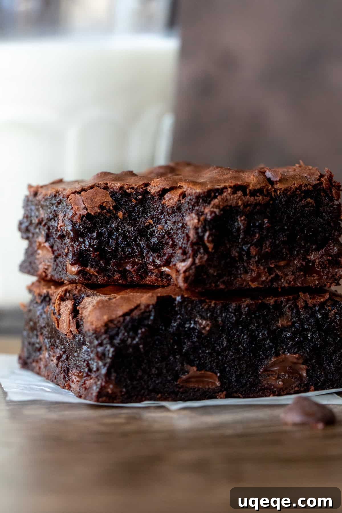 Perfectly Chewy Fudgy Homemade Brownies with Rich Cocoa 9 Two gooey chocolate chip brownies stacked on top of each other with a glass of milk