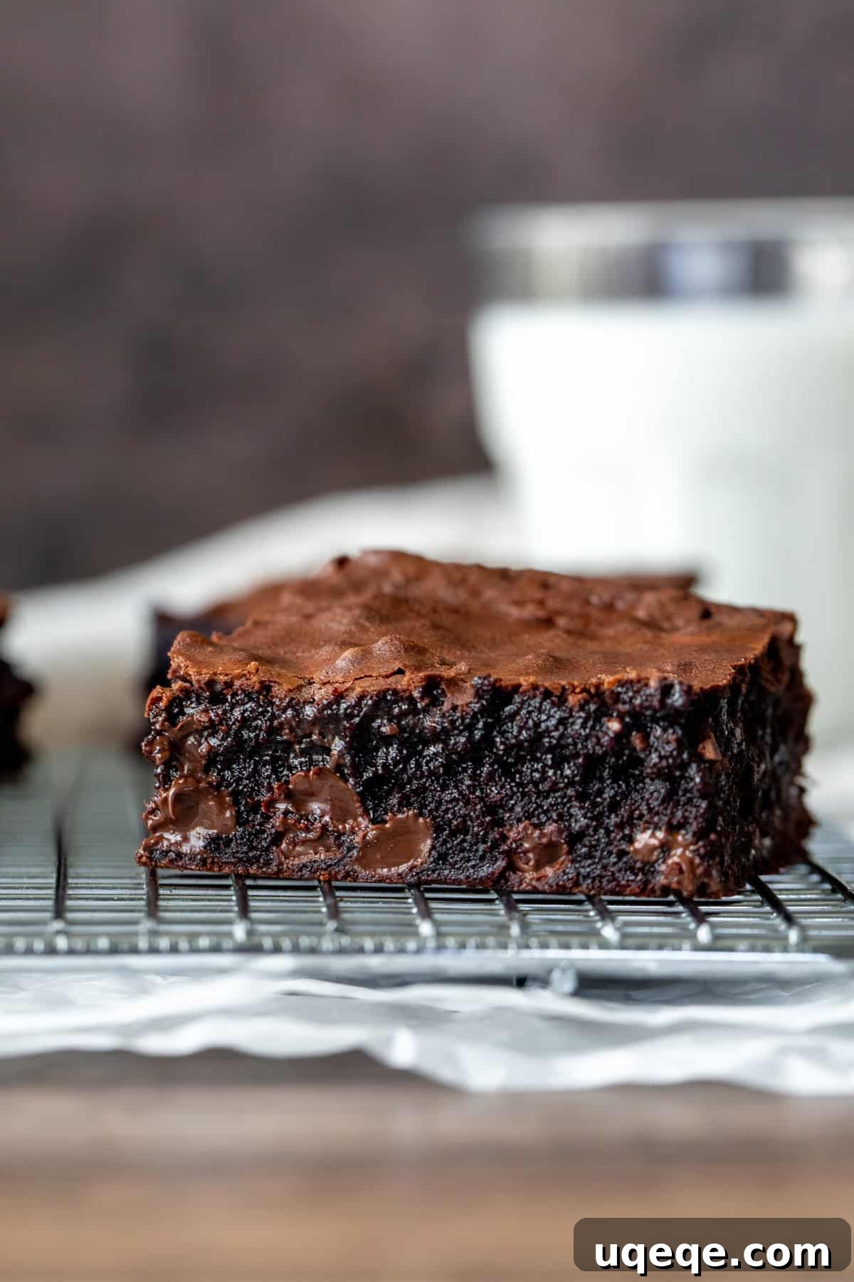 Perfectly Chewy Fudgy Homemade Brownies with Rich Cocoa 10 Gooey brownie cooling on a rack with a glass of milk in the background