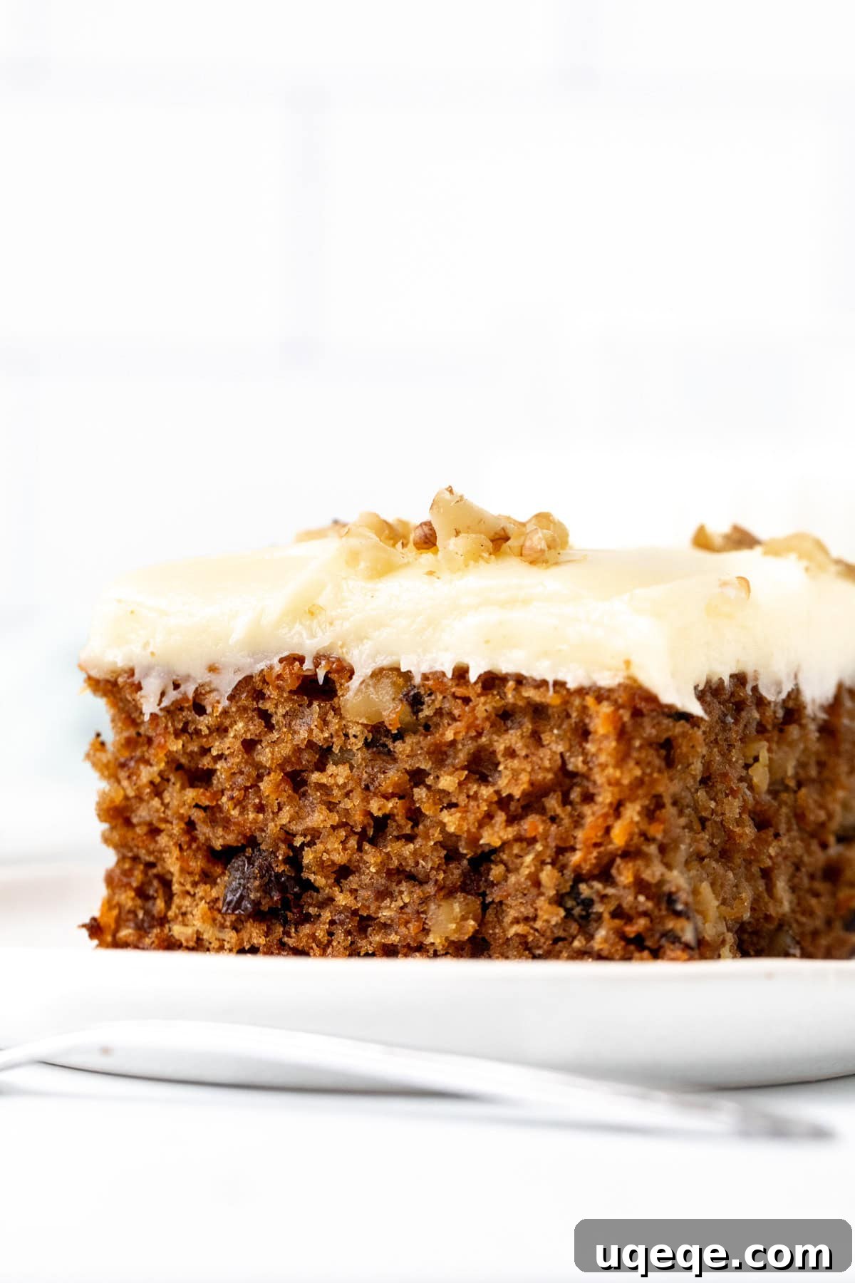 Decadent Moist Carrot Cake 2 Piece of moist carrot cake with cream cheese frosting and chopped walnuts on top