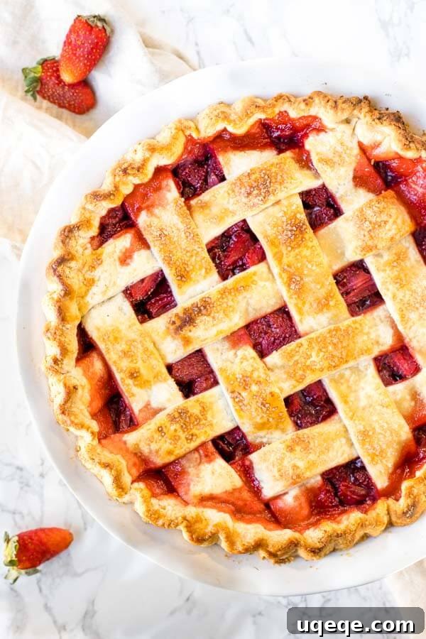 Sweet Strawberry Dream 4 A perfectly baked homemade strawberry pie, featuring a golden-brown lattice crust and visible juicy strawberry filling underneath.