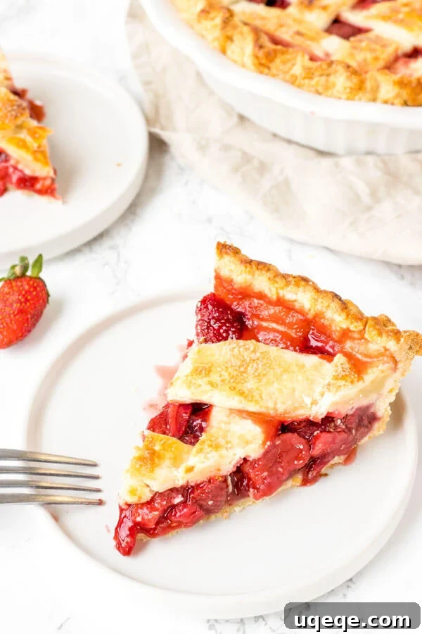 Sweet Strawberry Dream 5 A perfectly cut slice of baked strawberry pie, revealing the thick, juicy berry filling and the intricate lattice crust.