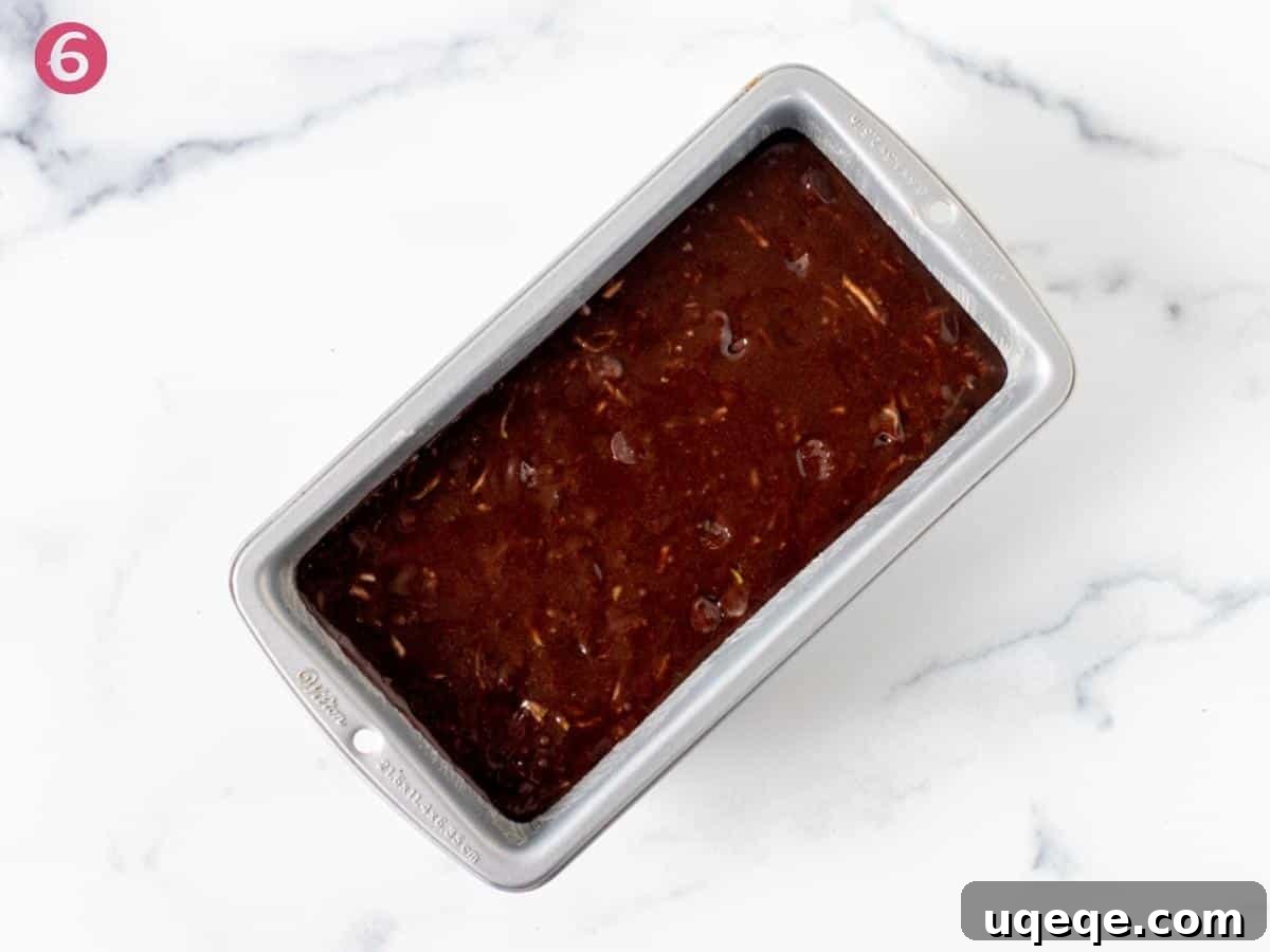 Decadent Chocolate Zucchini Loaf 5 Loaf pan filled with unbaked chocolate zucchini bread batter, ready for the oven
