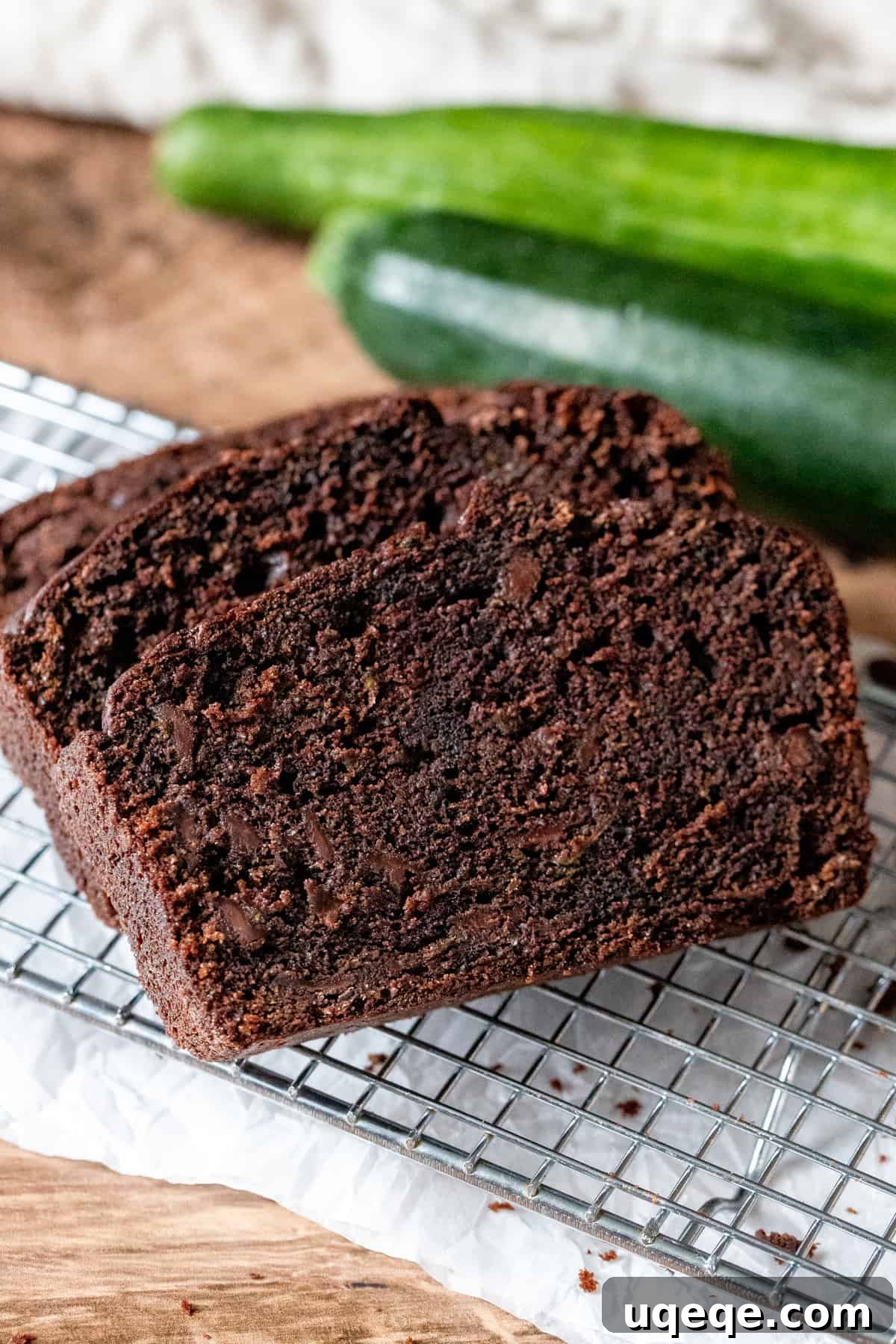 Decadent Chocolate Zucchini Loaf 6 Slices of moist chocolate zucchini bread cooling on a wire rack, showcasing its tender crumb