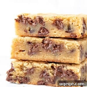 Stack of three chewy blondies with chocolate chips