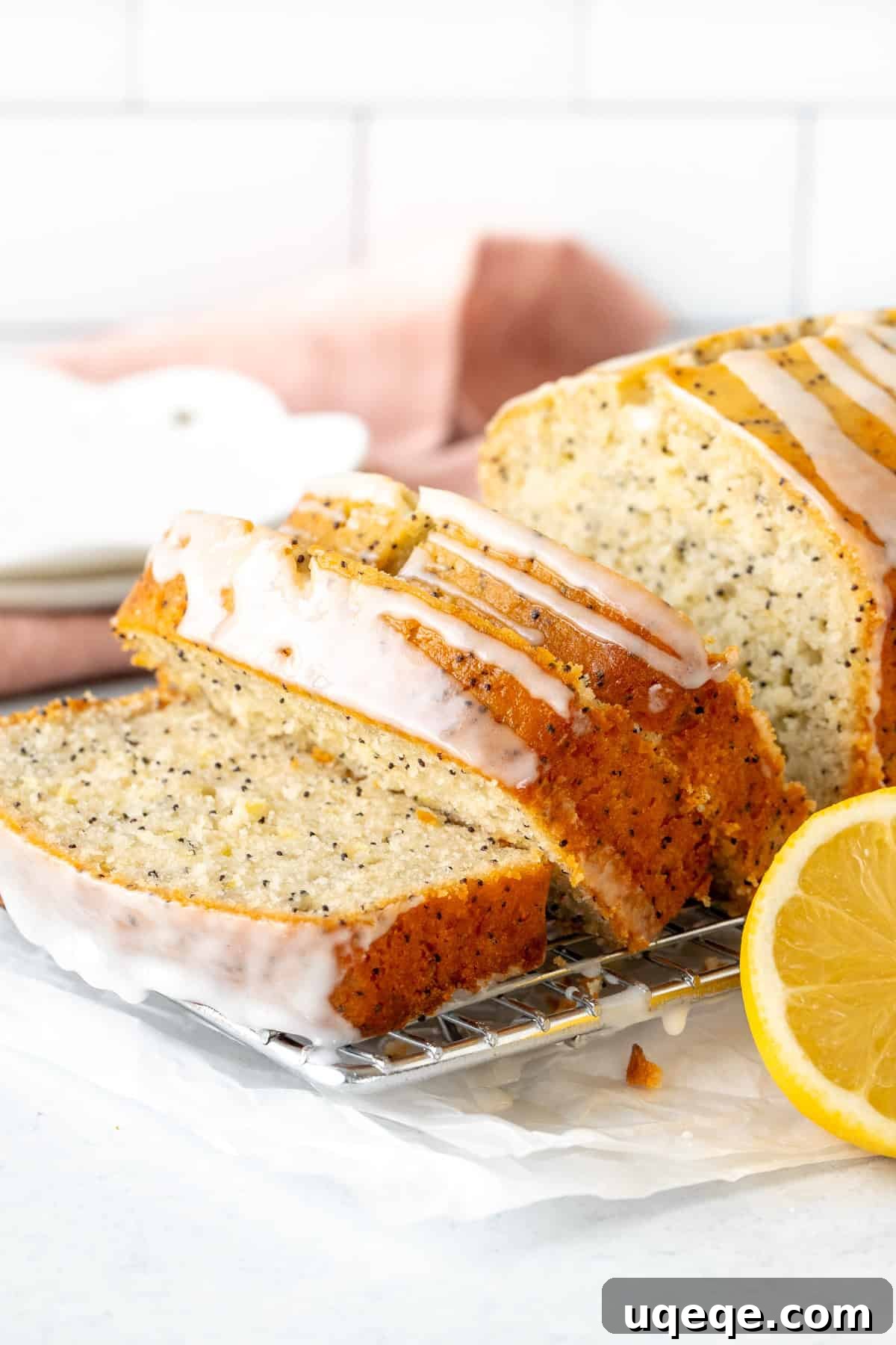 Lemon Poppy Seed Loaf 3 Three slices of lemon poppy seed bread with lemon glaze on a cooling rack