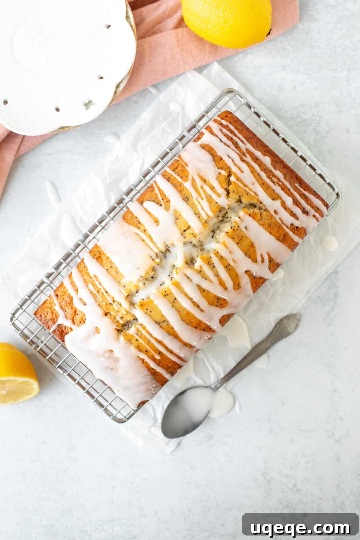 Lemon Poppy Seed Loaf 7 Lemon poppy seed loaf drizzled with lemon glaze, on a cooling rack