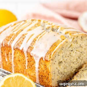 Lemon Poppy Seed Loaf 9 A freshly baked lemon poppy seed loaf on a cooling rack, ready to be sliced and glazed.