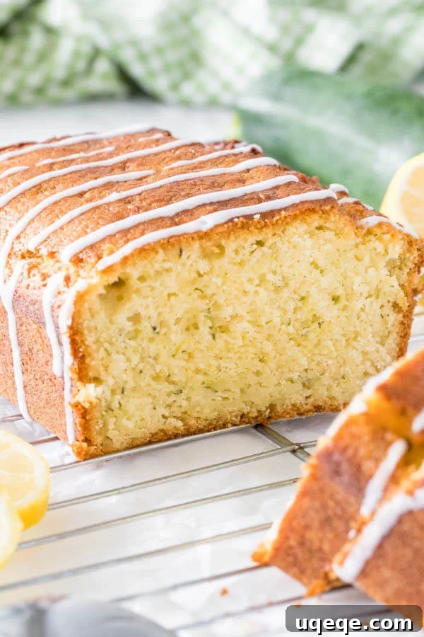 Zesty Lemon Zucchini Loaf 2 Glazed lemon zucchini bread, incredibly moist and tender, adorned with a vibrant lemon glaze, perfect for a refreshing summer treat and family gatherings.