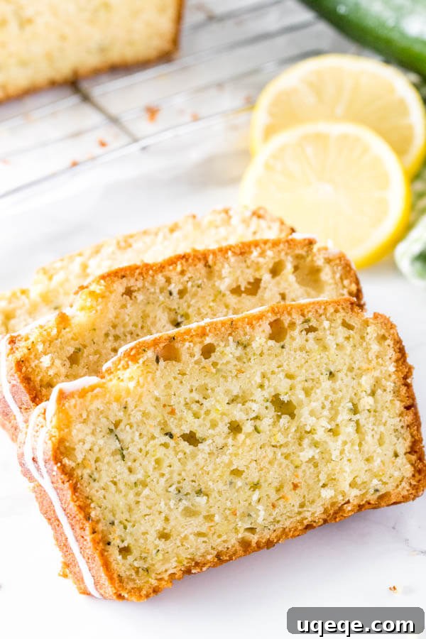 Zesty Lemon Zucchini Loaf 5 Three perfectly sliced pieces of lemon zucchini bread, showcasing its incredibly soft, tender, and consistently moist interior, a true testament to the enriching moisture from grated zucchini.