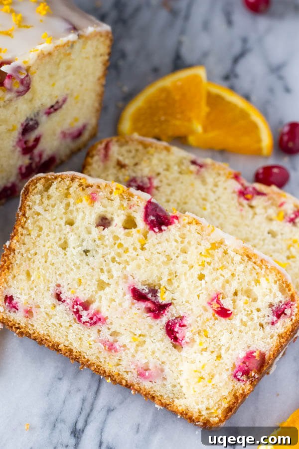 Golden Cranberry Orange Loaf 5 Freshly baked Glazed Cranberry Orange Loaf, cooling on a wire rack before the glaze is applied. Emphasizes the golden-brown crust and soft interior.
