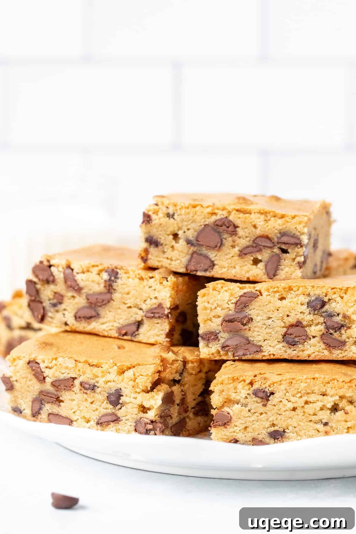 Ultimate Chewy Chocolate Chip Bars 3 A beautifully arranged plate of freshly baked chocolate chip cookie bars, ready to be enjoyed.