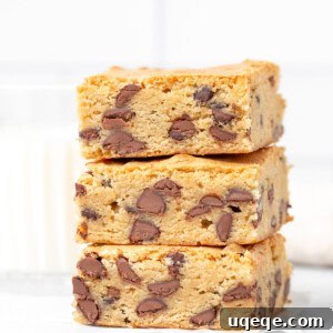 Three chocolate chip cookie bars, one on top of each other, ready to be served.