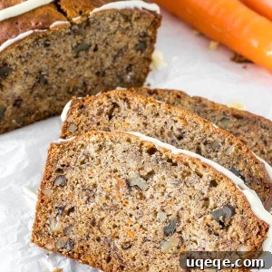 Close up of 3 slices of banana carrot bread with the rest of the loaf and 2 carrots to show the moist crumb.