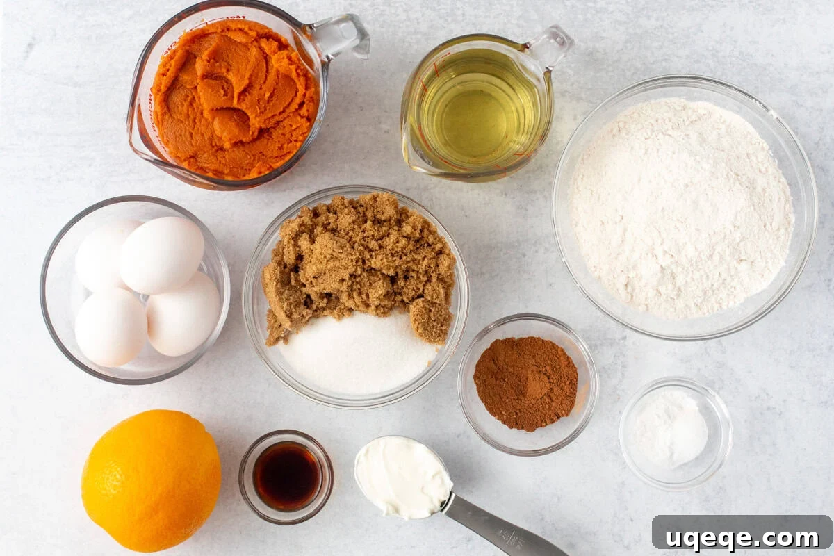 Spiced Pumpkin Bundt Delight 4 A flat lay image showing all ingredients for pumpkin bundt cake laid out on a table
