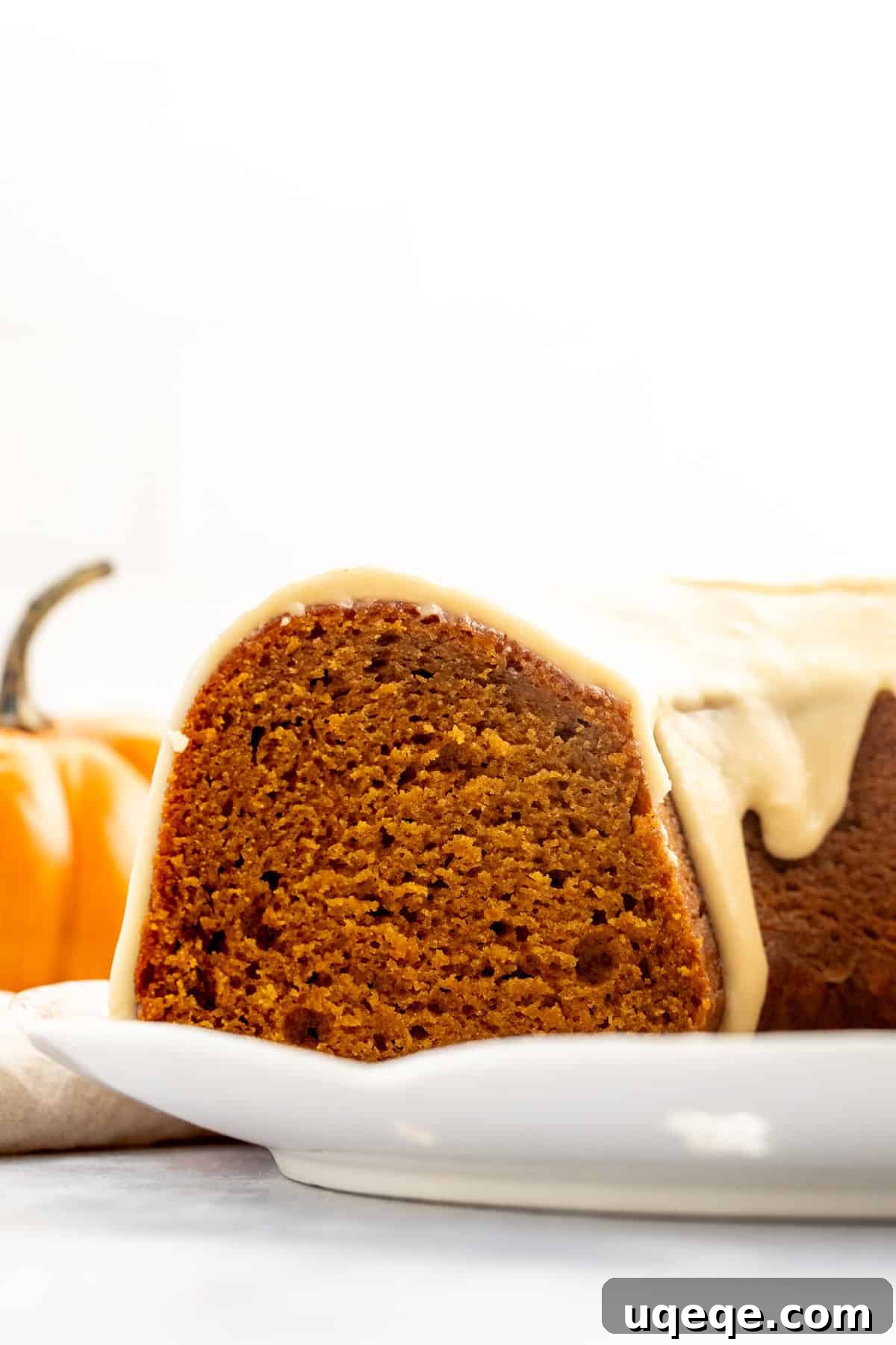 Spiced Pumpkin Bundt Delight 9 A cross-section of a pumpkin bundt cake with glaze, highlighting the moist, dense interior