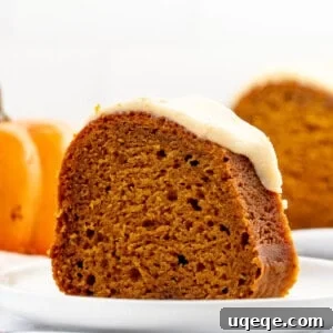 Slice of pumpkin bundt cake with maple glaze