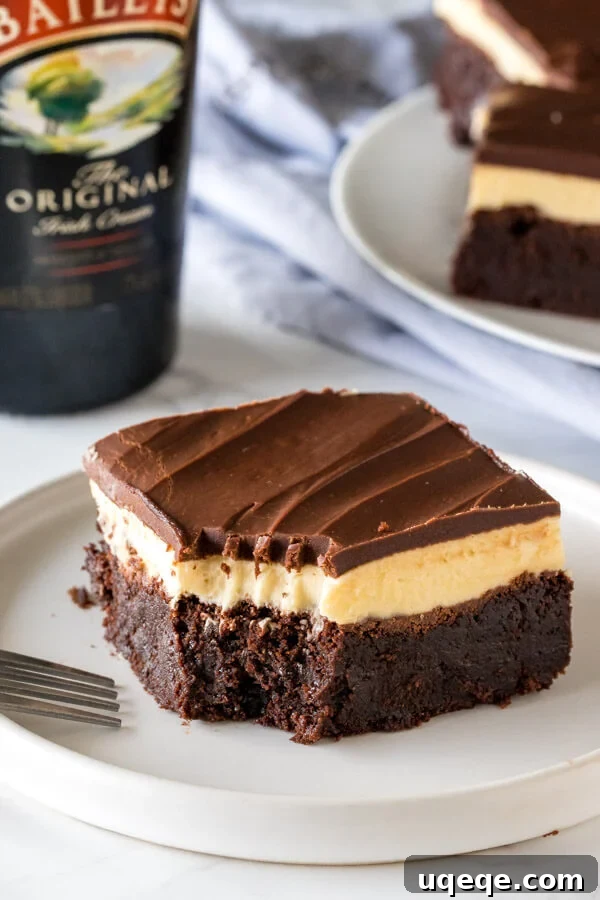Decadent Baileys Brownies 4 A Baileys brownie with a bite taken out of it to show the 3 layers and fudgy texture.