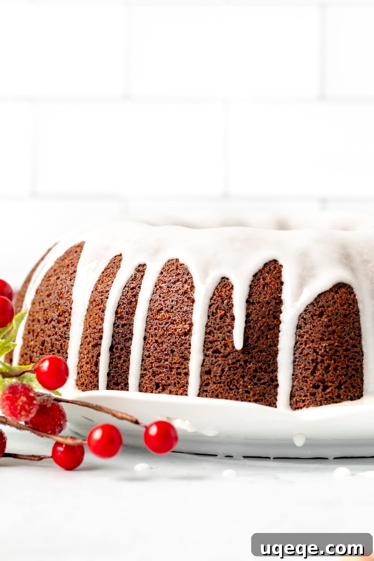 Molasses Spiced Bundt Bliss 3 Beautifully baked round gingerbread bundt cake, generously topped with a sweet lemon glaze, presented on a festive table.