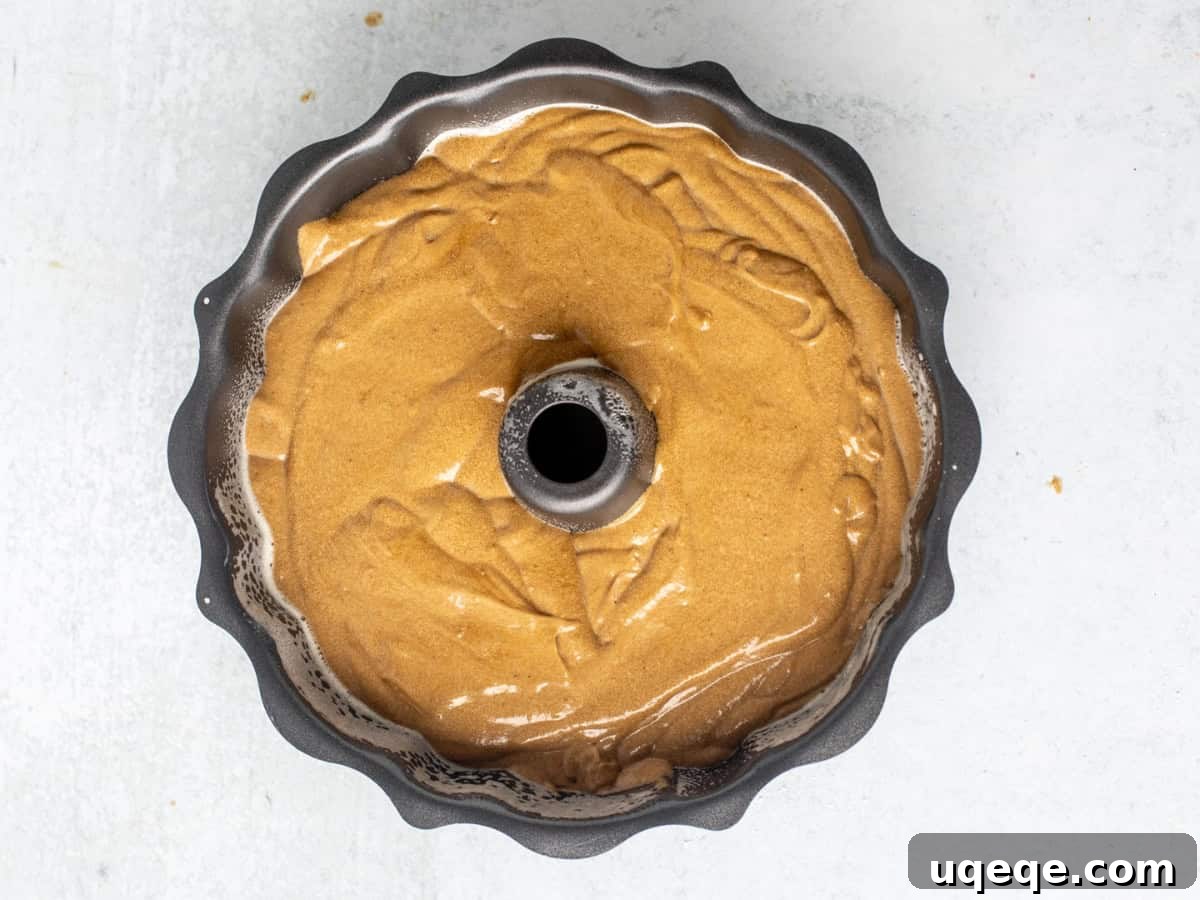Molasses Spiced Bundt Bliss 8 Unbaked gingerbread bundt cake batter in a perfectly prepared bundt pan, smoothed and ready to be placed into the preheated oven.