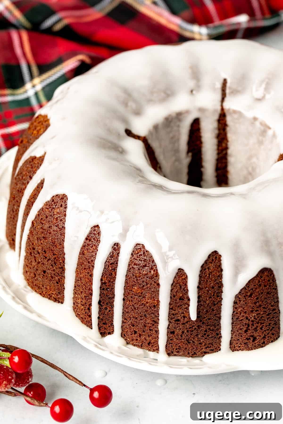 Molasses Spiced Bundt Bliss 9 A stunning gingerbread bundt cake, freshly baked and elegantly glazed with a delicate lemon icing, cooling on a wire rack, enticing with its festive aroma.