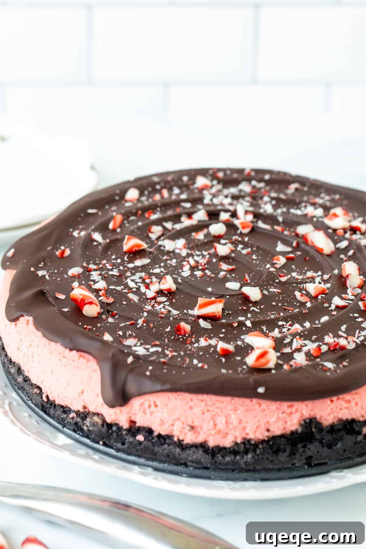 Arctic Peppermint Cheesecake 9 9-inch round peppermint cheesecake topped with chocolate ganache and crushed candy canes
