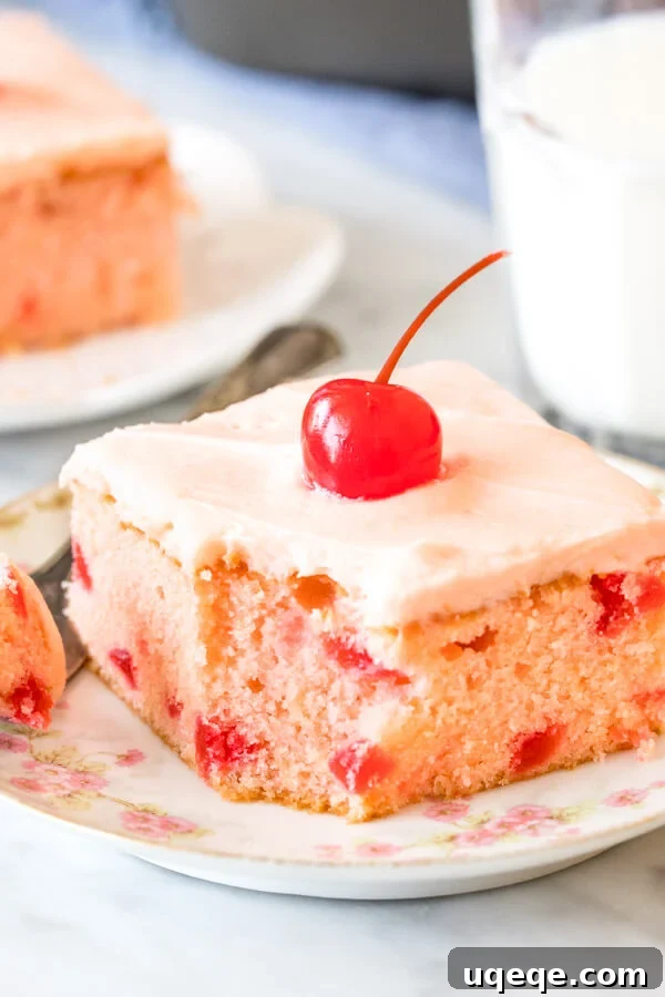 A slice of cherry chip cake with a bite taken out of it.