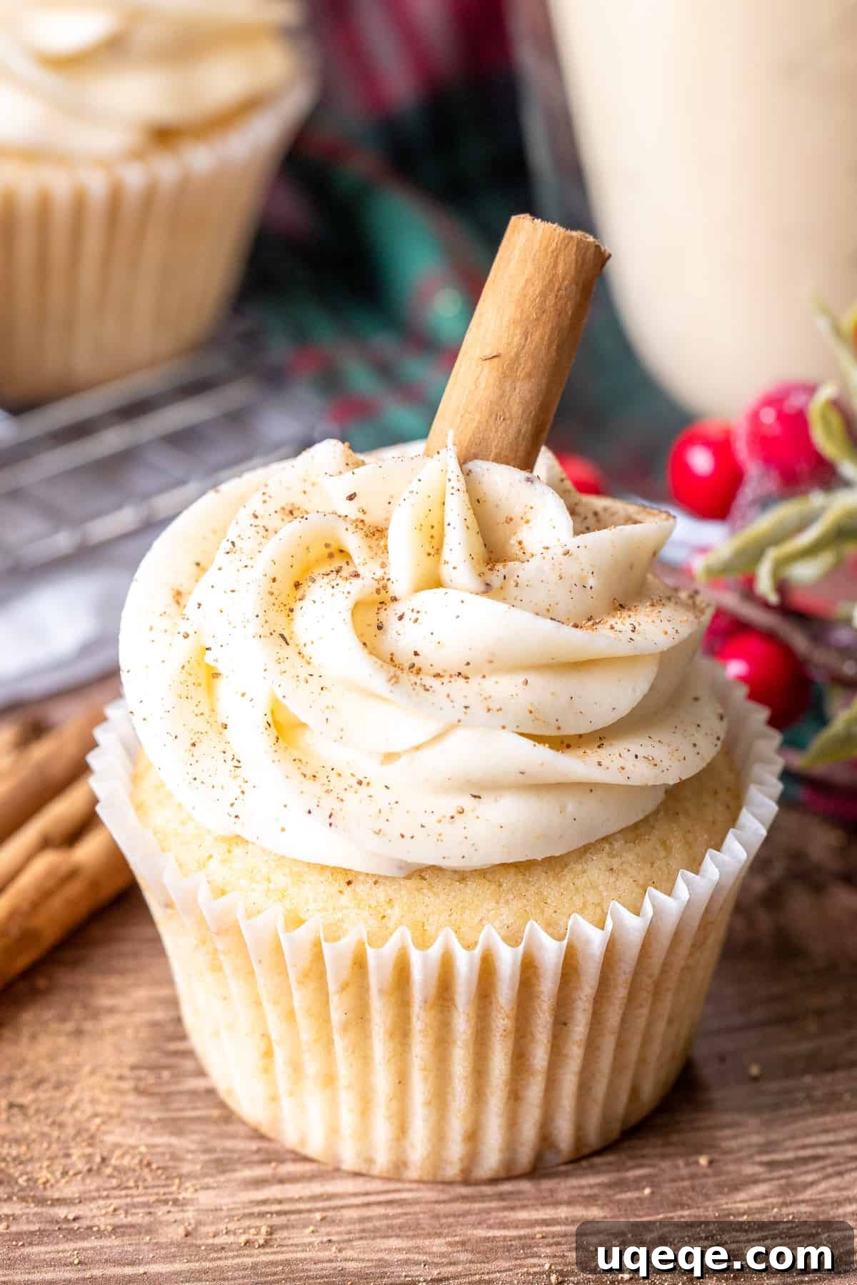 Festive Eggnog Cupcakes 2 Eggnog cupcake topped with eggnog frosting and a cinnamon stick