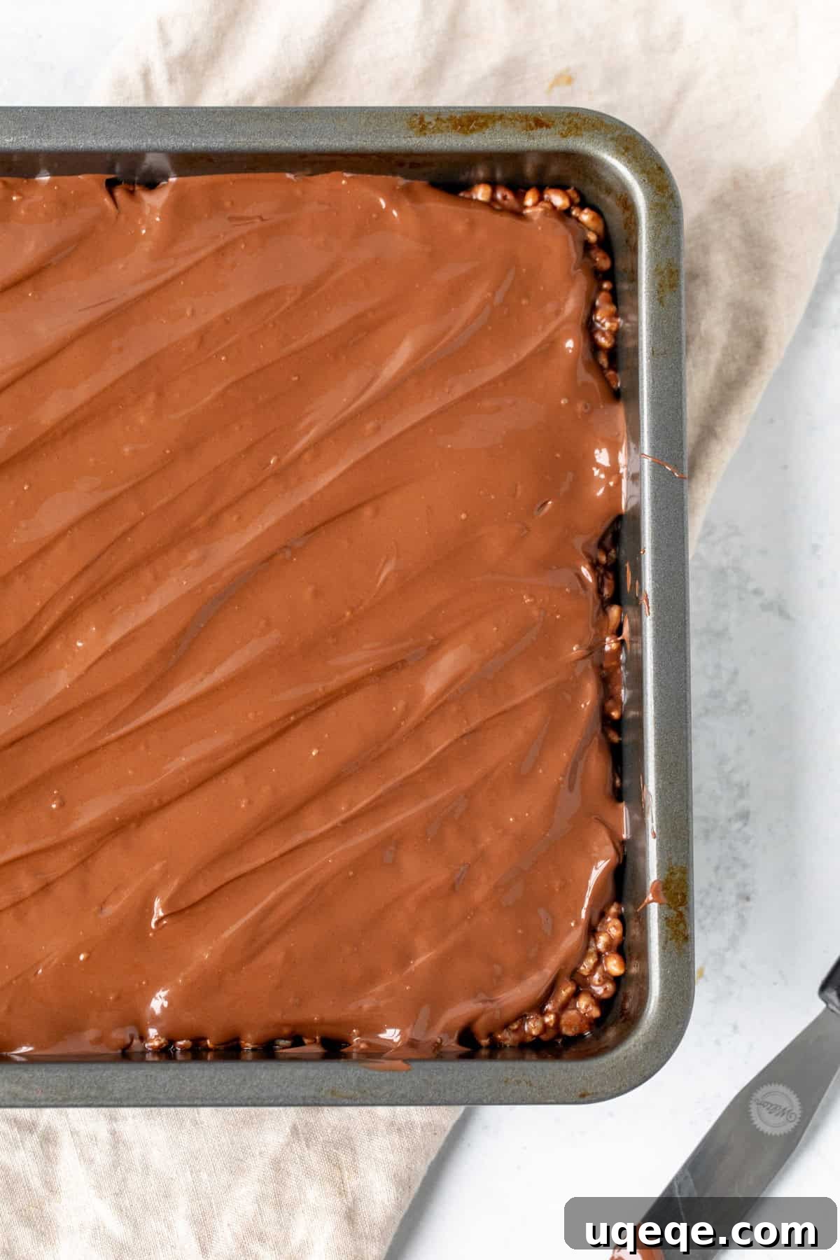 Decadent Chocolate Krispie Bars 5 Finished chocolate Rice Krispie treats with a glossy chocolate topping, neatly sliced and ready to serve.
