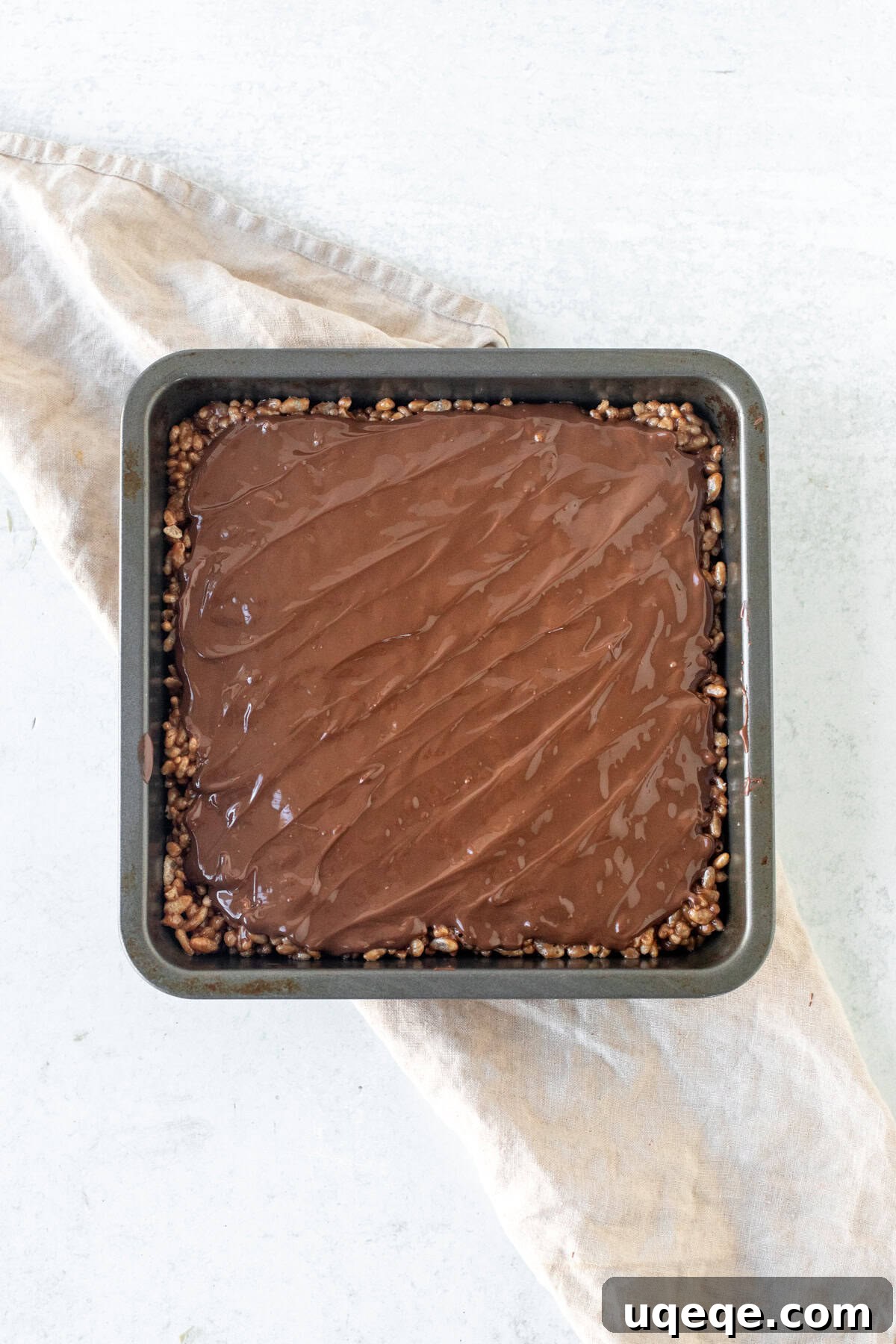 Irresistible Mars Bar Squares 5 A full pan of Mars Bar Rice Krispie treats, glistening with a freshly spread chocolate topping
