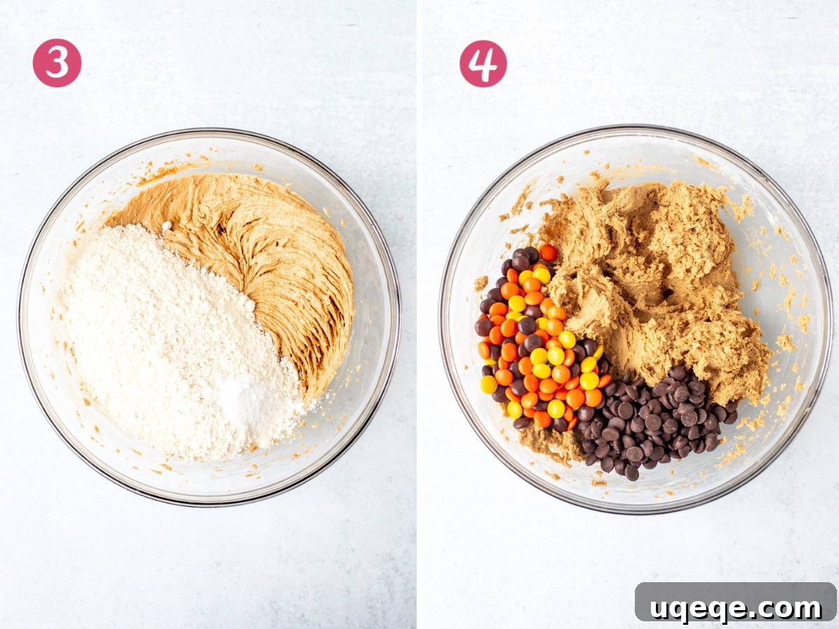 Peanut butter cookie dough in a bowl, with chocolate chips and Reese's Pieces mixed in, ready for chilling.