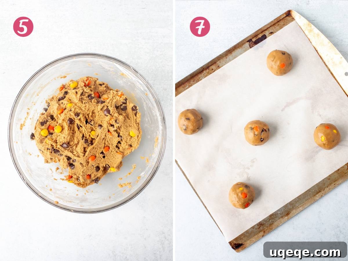 Bowl of Reese's Pieces cookie dough covered with plastic wrap, next to a baking tray with pre-formed cookie dough balls.