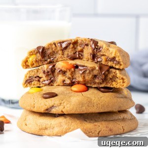 Reese's Pieces Peanut Butter Cookie Perfection 7 Stack of Reese's Pieces peanut butter cookies, with the top cookie broken in half, revealing its chewy interior.