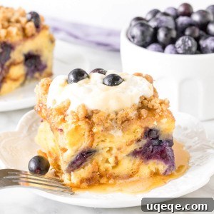 Overnight Blueberry French Toast Bake 5 Slice of blueberry french toast casserole with whipped cream on top.