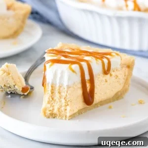 Golden Caramel Bliss Pie 5 Slice of no-bake caramel cream pie with a bite taken out of it.