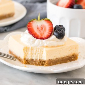 Slice of cheesecake bar with a bite taken out of it.
