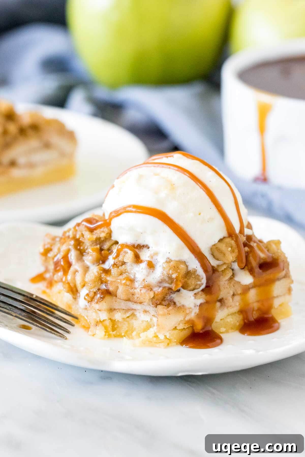 Homestyle Apple Crisp Bars 5 A delectable apple crisp bar with a rich shortbread crust and a generous scoop of melting vanilla ice cream on top, ready to be enjoyed.