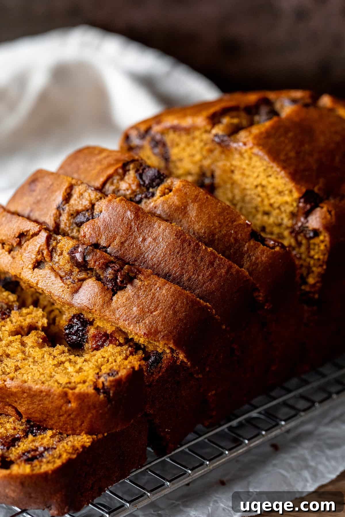 Spiced Pumpkin Chocolate Chip Bread 2 Pumpkin chocolate chip bread on a cooling rack with 5 pieces sliced, ready to be enjoyed as a comforting fall treat.