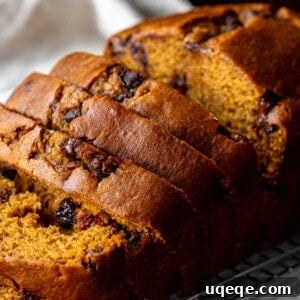 Spiced Pumpkin Chocolate Chip Bread 8 Pumpkin chocolate chip bread on a cooling rack with 5 pieces sliced