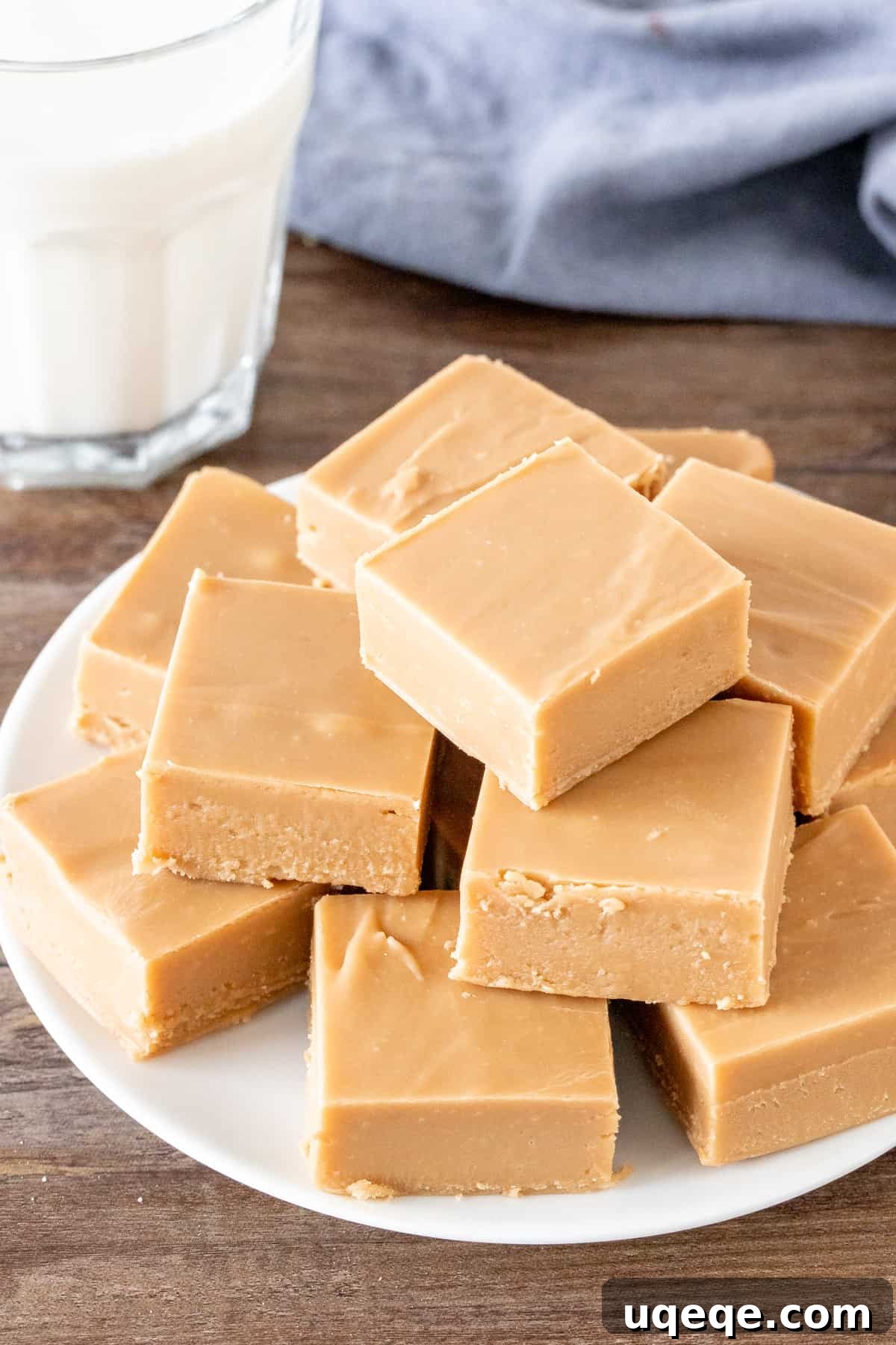 Effortless Condensed Milk Caramel Fudge 2 Plate of easy caramel fudge squares with a glass of milk, highlighting its creamy texture