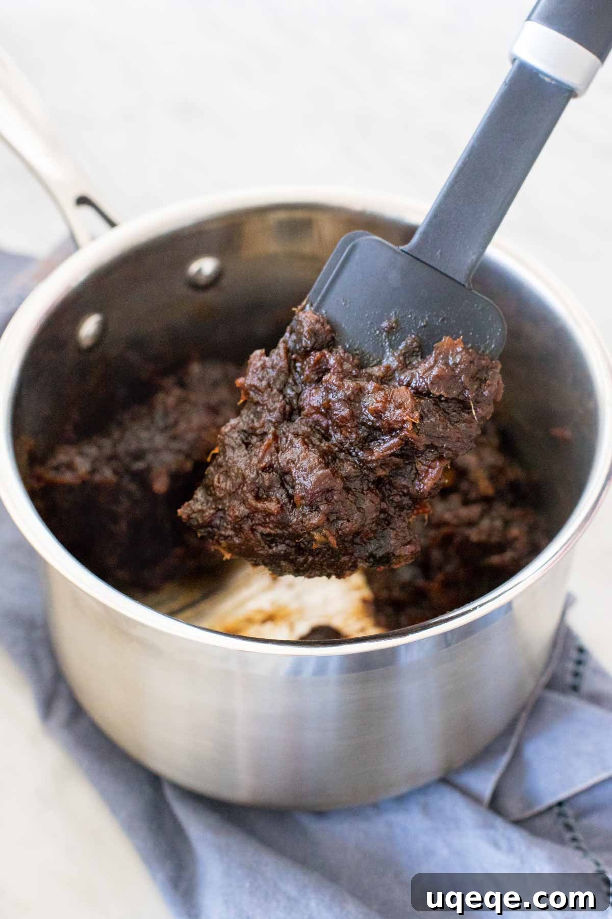 Golden Date Crumb Bars 3 Boiled date mixture simmering in a saucepan, ready to be spread into a delicious date square filling.