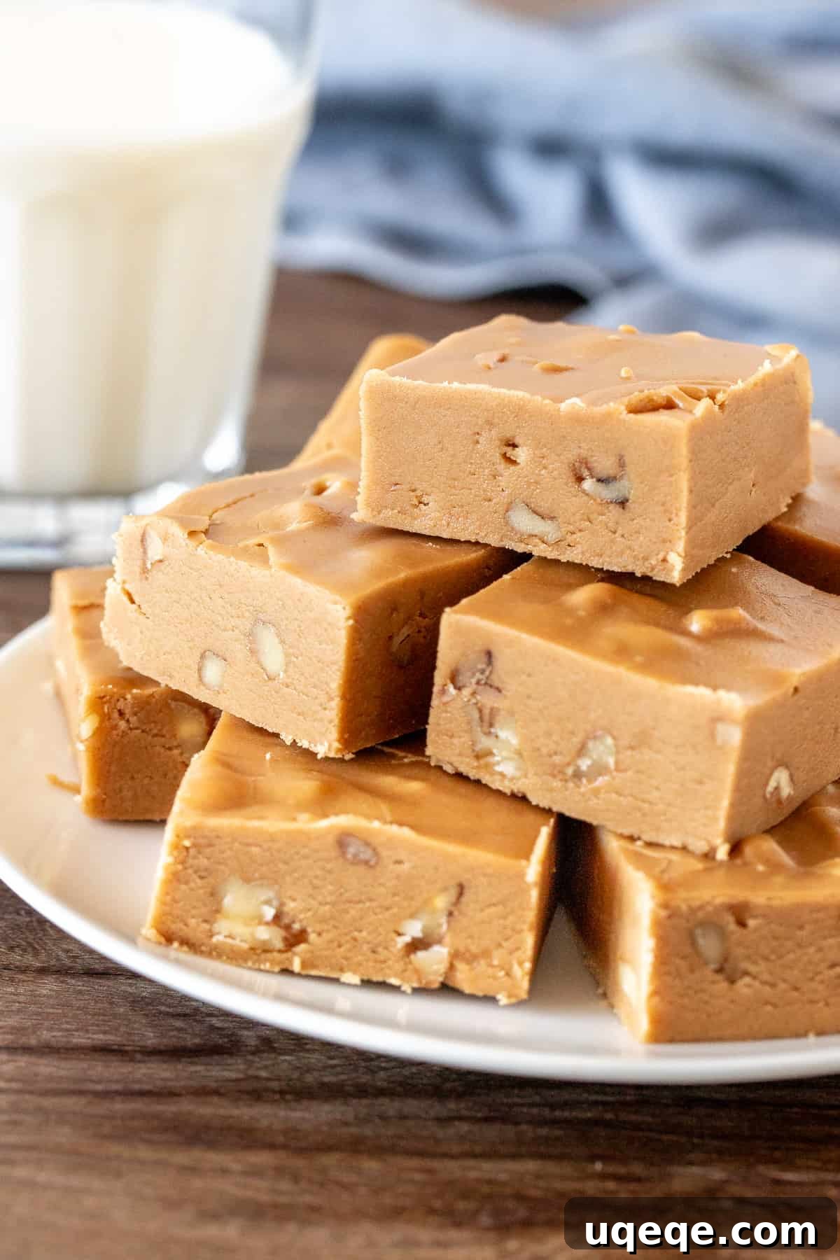Sweet Brown Sugar Bliss 4 Perfectly cut squares of golden brown sugar fudge, neatly arranged on a white plate, showcasing its appealing texture and readiness to be served.