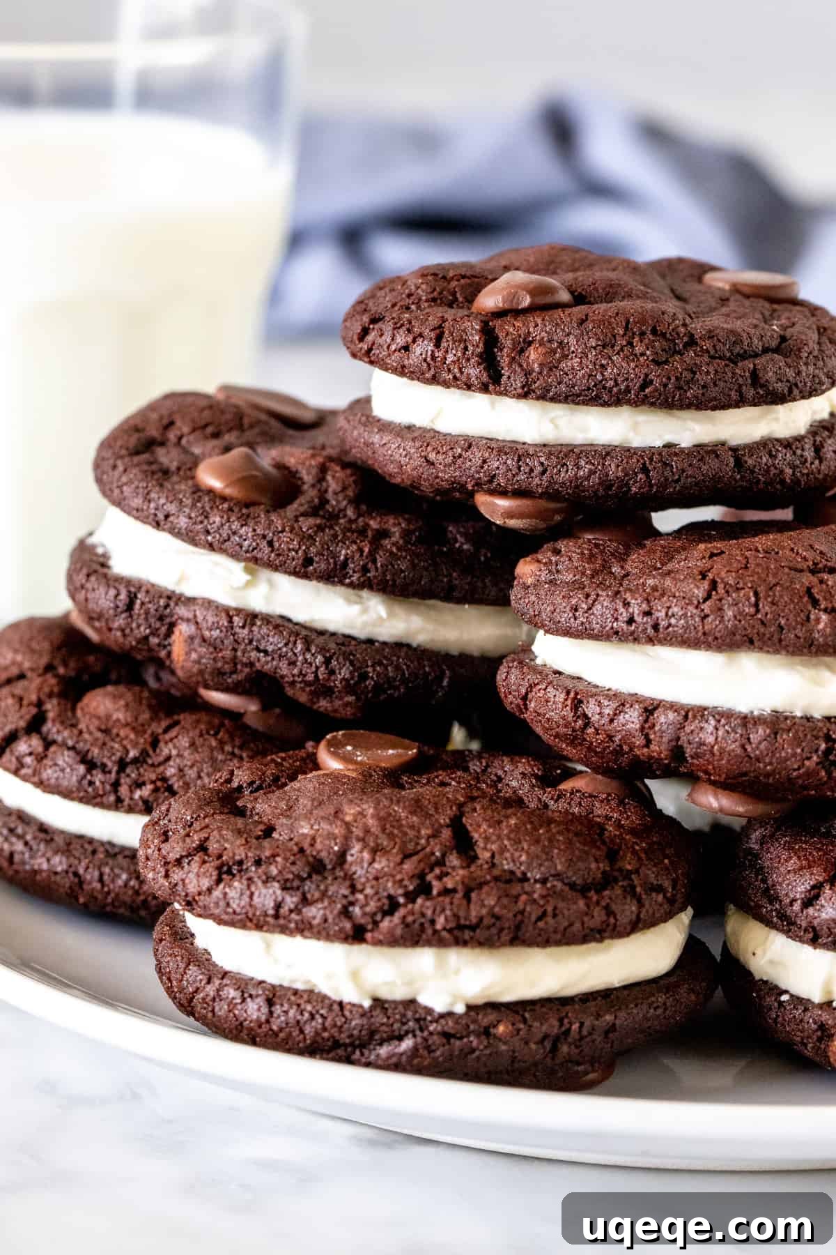 Decadent Chocolate Cremes 2 Plate of chocolate sandwich cookies with a glass of milk.