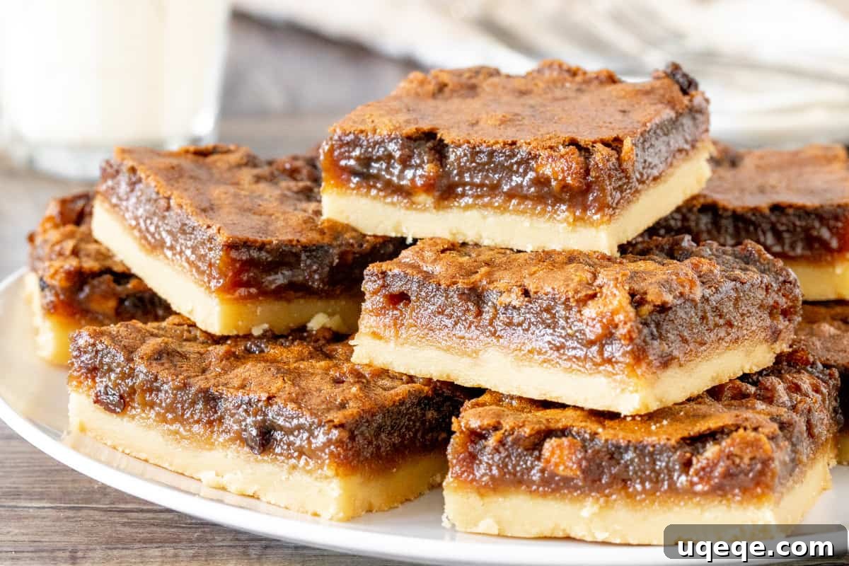 A charming plate showcasing several butter tart squares, neatly stacked and arranged, ready to be enjoyed as a delightful dessert.
