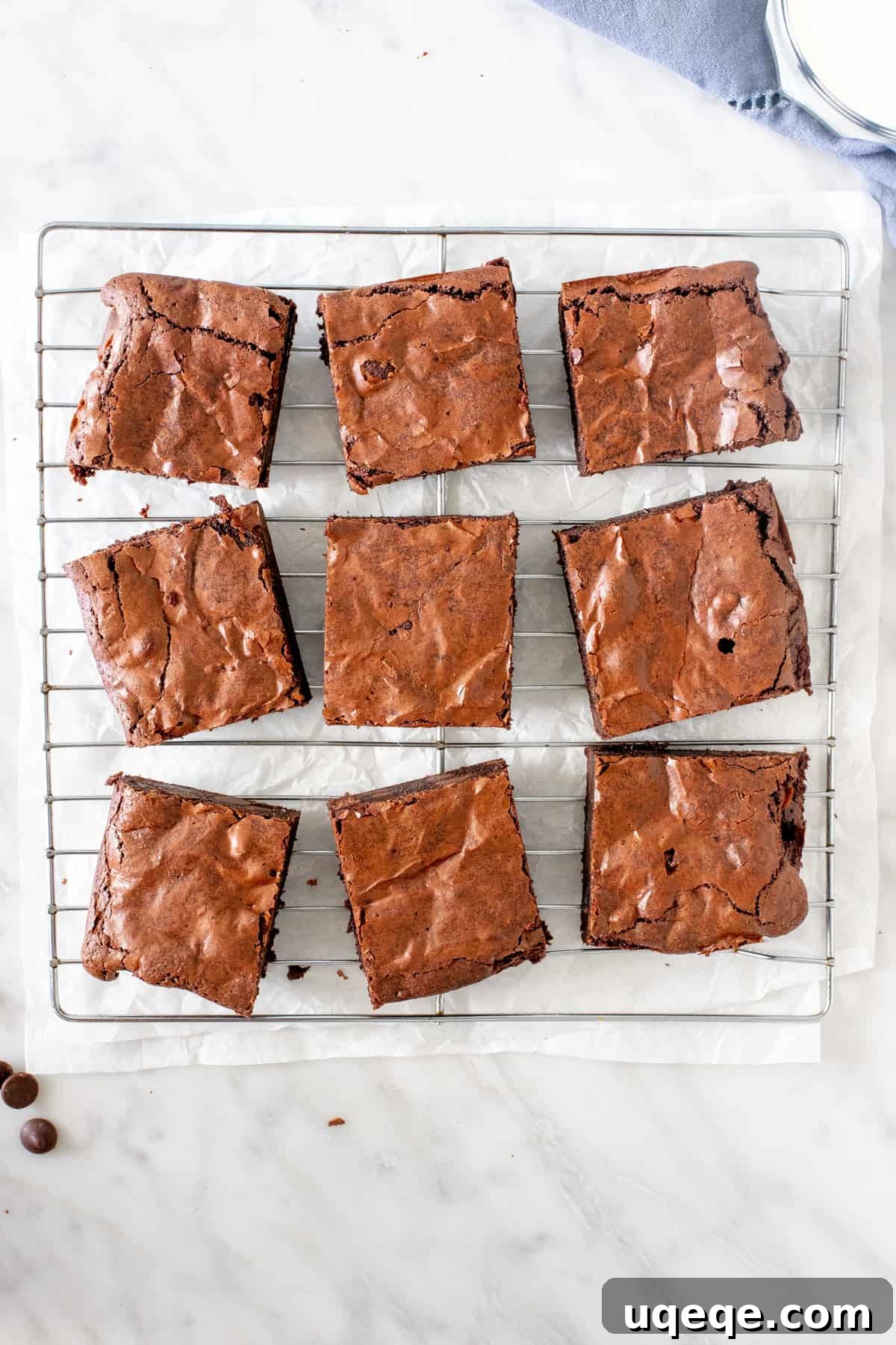 Fudgy Flourless Brownies 3 Nine perfectly baked flourless brownies cooling on a wire rack.