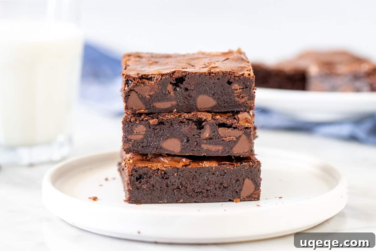 Fudgy Flourless Brownies 4 Three decadent gluten-free flourless brownies stacked artfully.